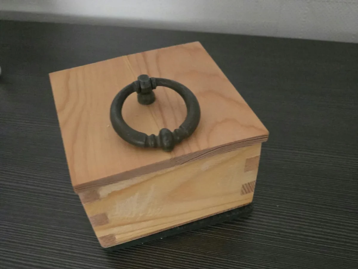 Geschlossene handgefertigte Holzschachtel mit Ringgriff